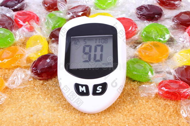 血糖仪，糖果和粒状红蔗糖，糖尿病的概念