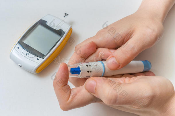 糖尿病的概念。 手拿针测量葡萄糖水平。