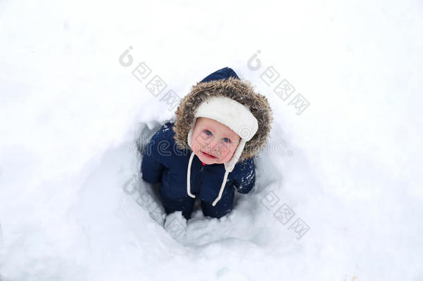 寒冷的婴儿在冬天的雪服在雪中