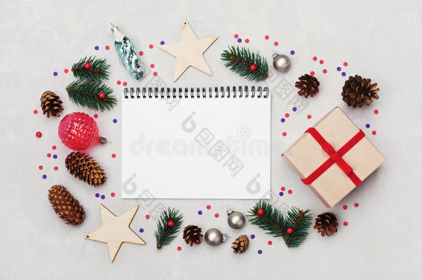 圣诞背景的<strong>笔记本</strong>，礼品盒，冷杉树，针叶锥和节日装饰在白色桌子上从<strong>上面</strong>。 平躺。