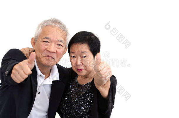 亚洲高级夫妇穿着商务服装，举手示意大拇指