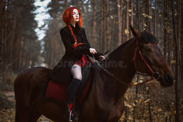勇敢的<strong>红</strong>头发女孩穿着一件黑色的外套和一件留着长发的<strong>红</strong>色连衣裙，聚集在<strong>辫子</strong>里