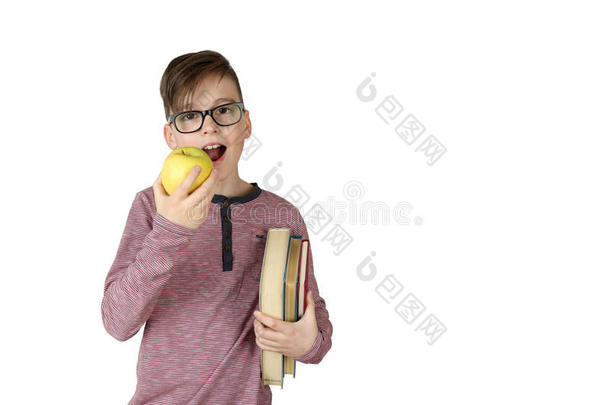男孩腋下夹着一叠书，吃着一个苹果