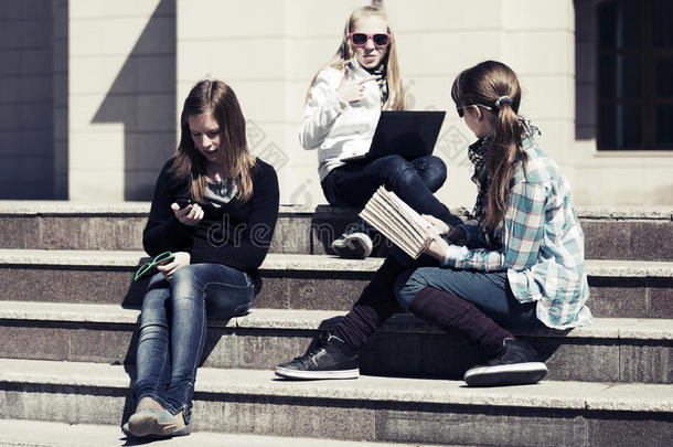 一群女孩坐在校园的台阶上