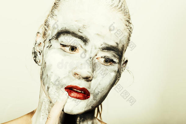 抽象艺术化妆。 脸和脖子的女孩涂上灰色和<strong>鲜红</strong>的嘴唇。 霍利节