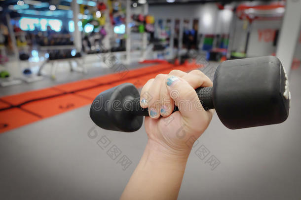手握哑铃在体育俱乐部或健身房和健身