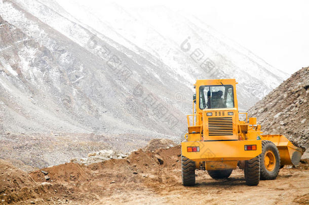 大型重型机械车辆犁沙和石头移动道路在雪山