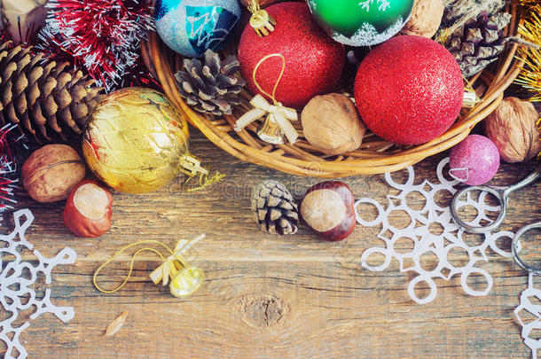 圣诞作文带礼物。 篮子，<strong>红球</strong>，松果，木桌上的雪花。 复古风格