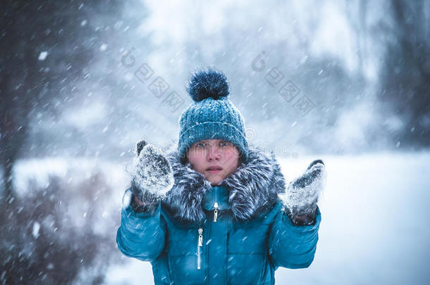 冬天公园里的女孩抓住雪花的手。 冬季景观。