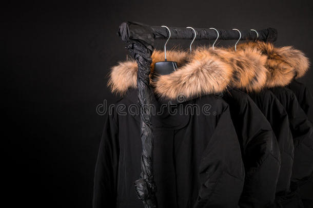 黑色外套，带毛皮的夹克衫挂衣架。 背景。 复制空间。