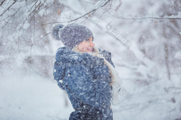 可爱的年轻女子肖像玩雪在温<strong>暖</strong>的羊毛帽和外套在<strong>冬季</strong>公园