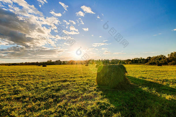 早秋日落时，田野里有干草堆