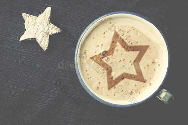 一杯卡布奇诺咖啡，泡沫形式的星星在蓝色的j