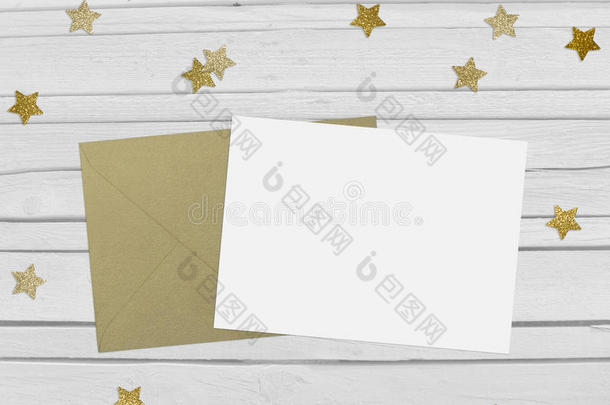圣诞节，新年派对的模拟场景与金星形状闪闪发光的五彩纸屑，空白纸和信封。白色