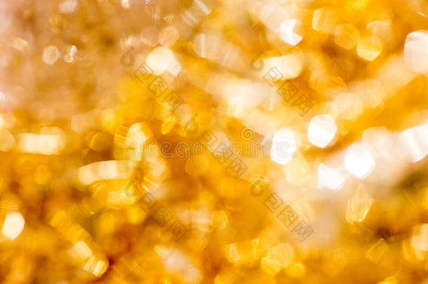 金色圣诞波克背景。 黄金假日发光抽象闪光散焦背景