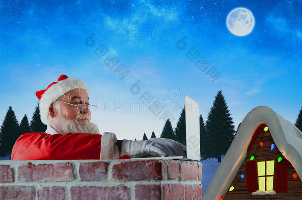 圣诞老人在烟囱上使用笔记本电脑的复合图像