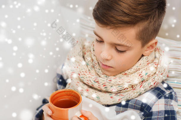 关闭生病的男孩流感在家里喝茶