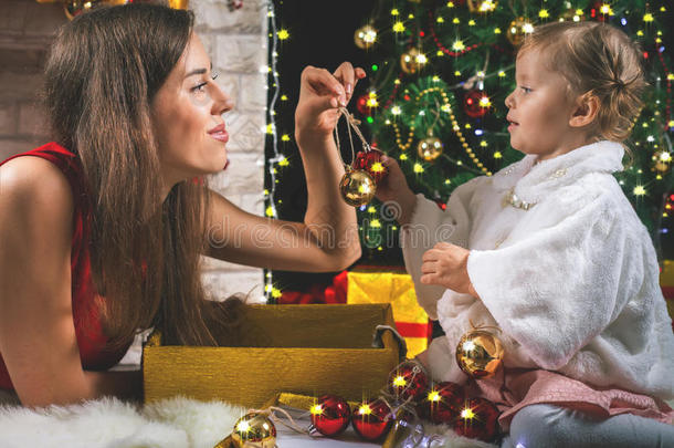 可爱的婴儿和<strong>妈妈装</strong>饰圣诞树。 红球。