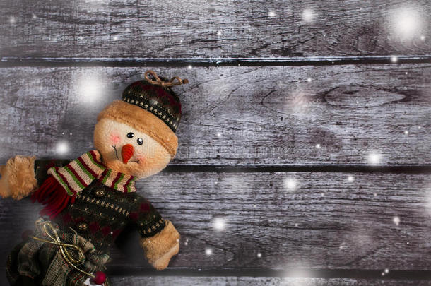 圣诞玩具雪人在一个木制背景雪