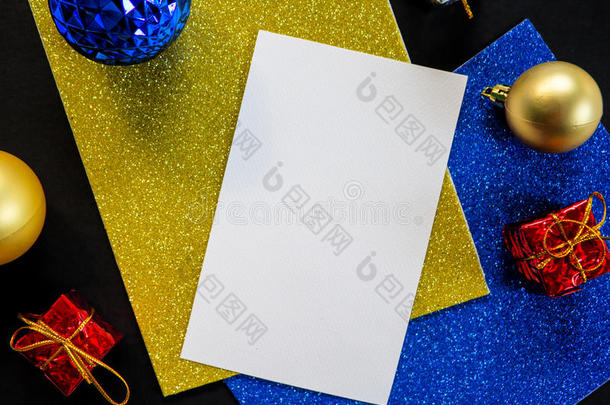 空白白纸，圣诞装饰品和闪光。 桌子上的圣诞树装饰品。
