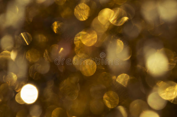 抽象的纹理，金色的闪光在阳光下闪闪发光。 光