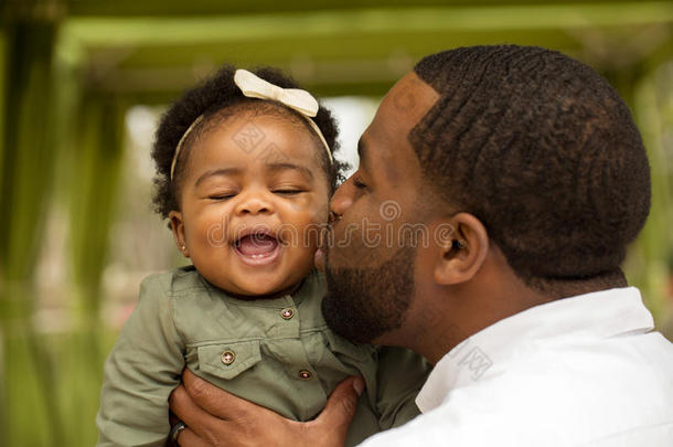 非裔美国父亲抱着他的女儿。
