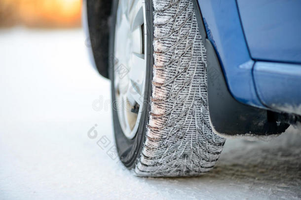 雪道上冬季汽车车轮的特写图像。 驾驶安全概念。