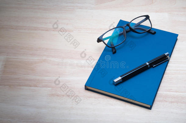 蓝色皮革笔记本和蓝色皮革笔记本和钢笔。