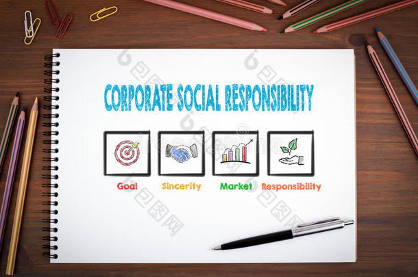 企业社会责任。 木制桌子上的笔记本、钢笔和彩色铅笔。