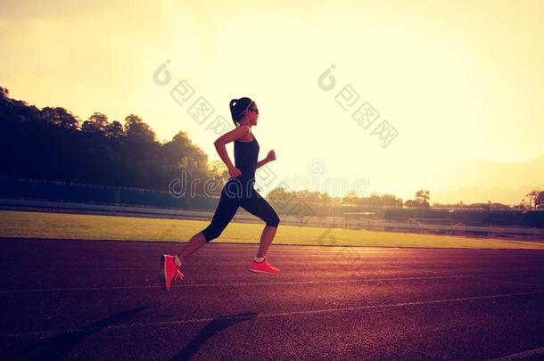 健身女子跑步运动员在<strong>体育场跑道</strong>上跑步