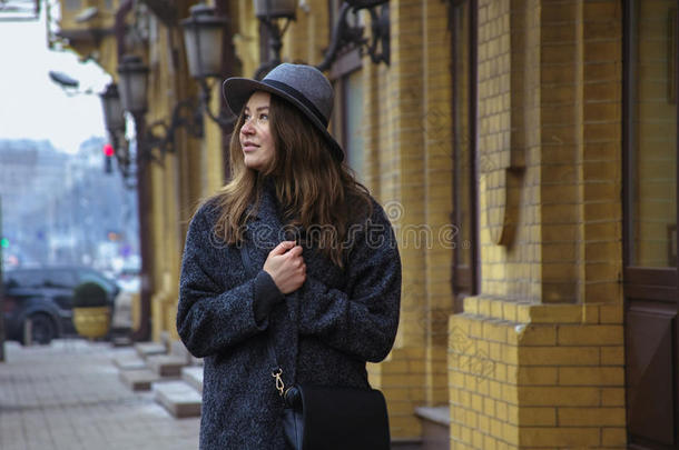 戴毡帽的女孩，在城市街道上走来走去，阴天，户外