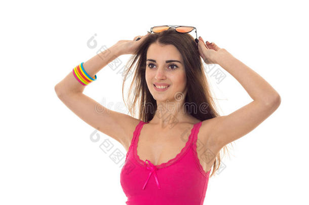 美丽的年轻女孩穿着粉红色的浅色衬衫，看着远方，微笑着孤立在白色的背景上