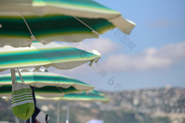 阳光明媚的夏日海滩上五颜六色的雨伞的细节。