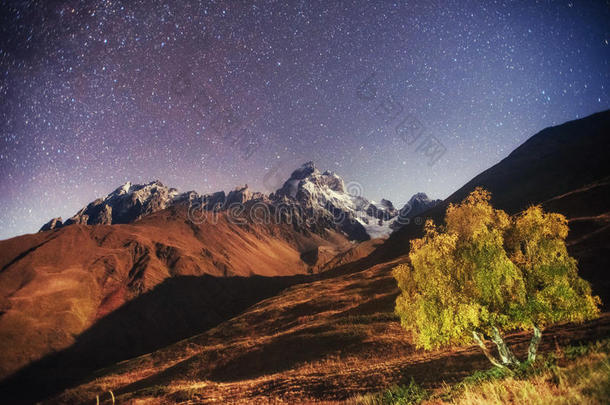 奇妙的星空。 秋天的风景和白雪皑皑的山峰