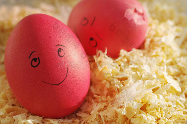 木屑上的复活节彩蛋。 两个有趣的复活节彩蛋和<strong>抽签</strong>的人。 快乐和悲伤的破碎的鸡蛋。