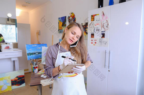 艺术家女孩手里拿着画笔，画在画布上，拿起ph