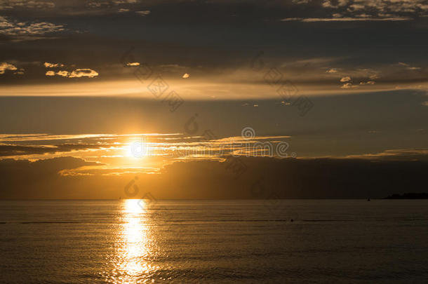 美丽的金色夕阳在平静的亚得里亚海，最后一束阳光在无波水面上形成了一条金色的道路。 用o启发
