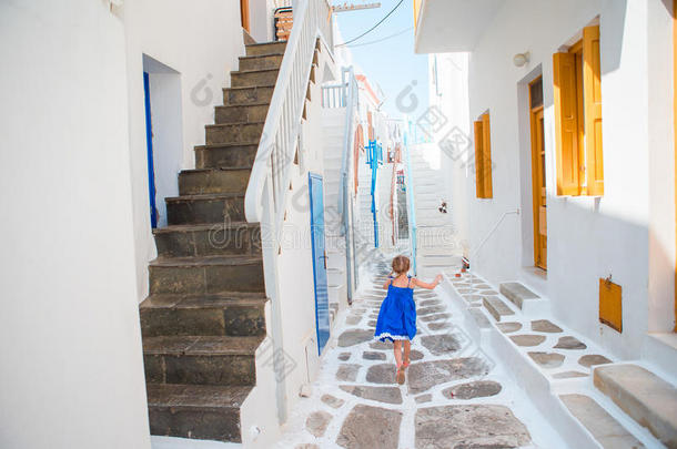 可爱的小女孩在街道上的典型希腊传统村庄在Mykonos岛，在希腊