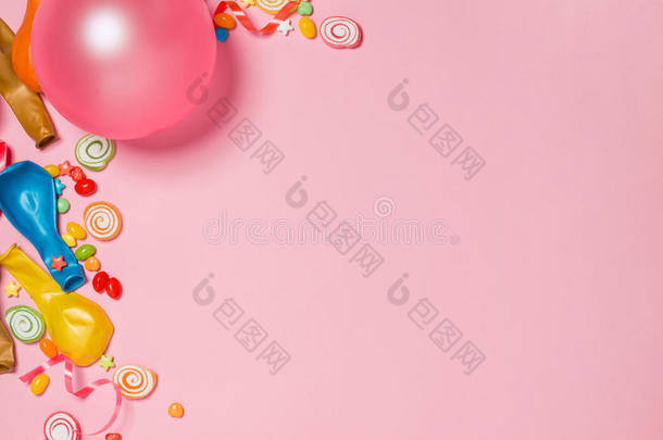 庆祝平躺。 糖果与五颜六色的派对项目在粉红色巴