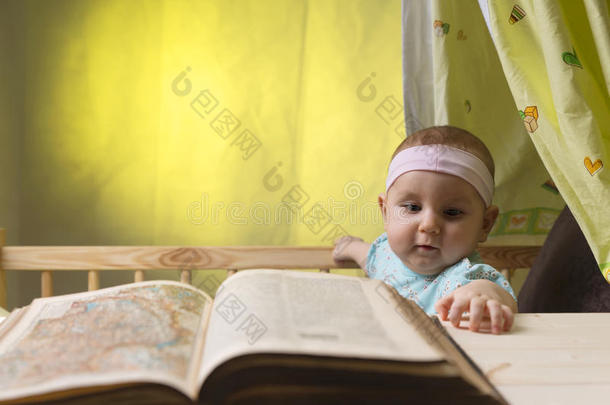 可爱的小宝宝在一本旧书旁边