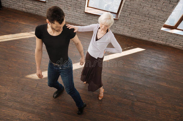 迷人的<strong>舞蹈老师</strong>在舞厅里帮助年迈的女人