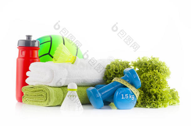 健身概念与运动设备。白色和绿色毛巾与两个蓝色哑铃包裹黄色测量带与绿色