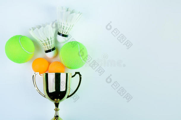 金色奖杯，毽子，乒乓球和网球隔离在白色背景与复制空间。概念赢家