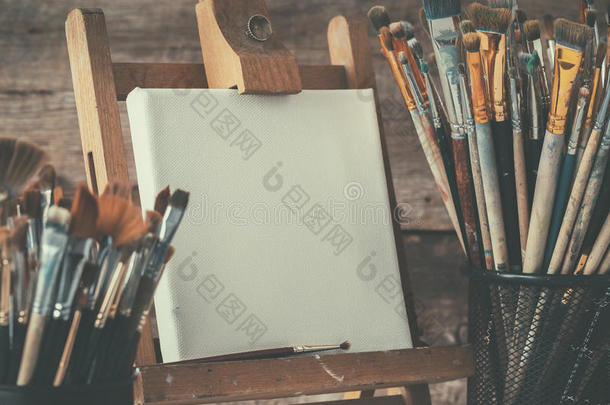 艺术设备：画架上的艺术家画布和画笔。