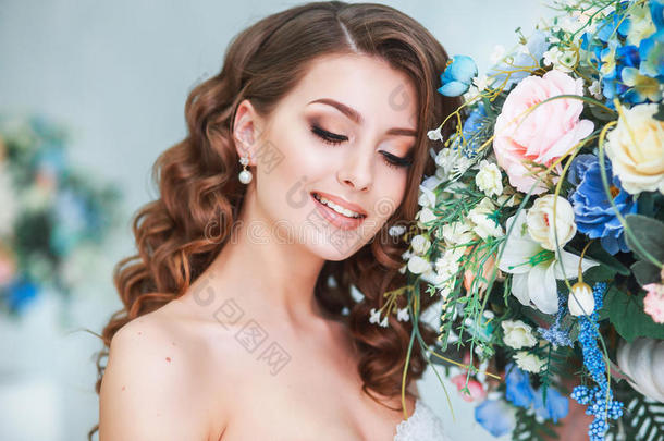 美丽的年轻新娘，婚礼化妆和发型室内。 摄影棚里年轻漂亮新娘的特写肖像