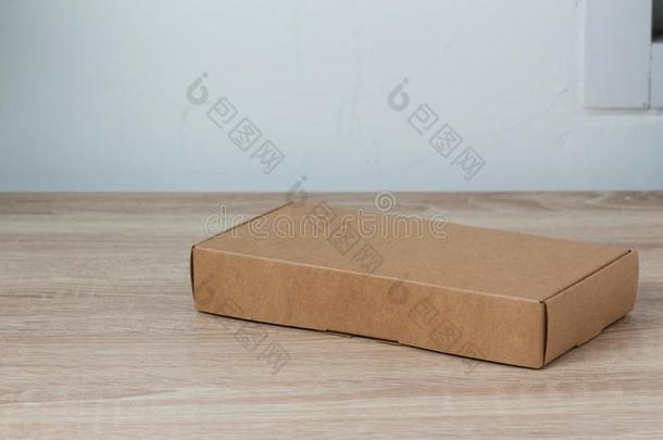 卡纸板盒或棕色的纸盒向木材背景