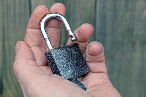 一敞开的灰色挂锁和一钥匙向指已提到的人敞开的p一lm