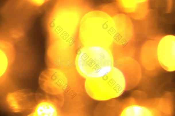 抽象的圆形的金色的闪耀闪烁焦外成像流动的运动