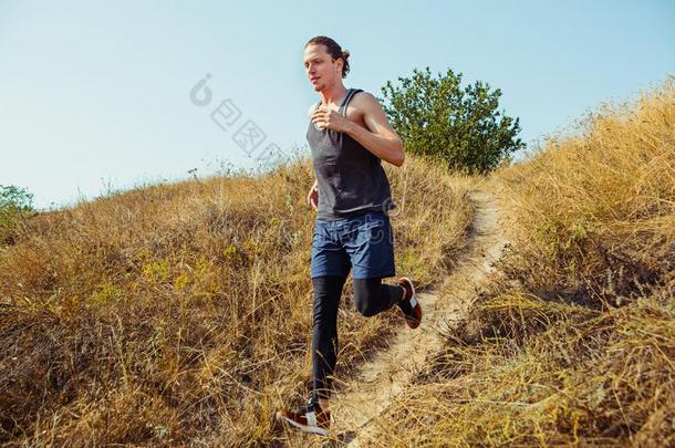 跑步运动.男人赛跑者短距离疾跑户外的采用风景优美的自然.Finland芬兰