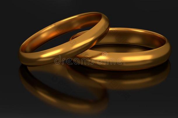 两个金色的婚礼戒指向黑暗的背景